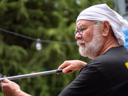 Man making pizzas in a brick oven